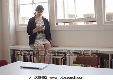 Caucasian businesswoman using cell phone in office View Large Photo Image Stock Image - Caucasian businesswoman using cell phone in office. Fotosearch