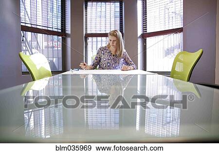 Stock Photo - Caucasian businesswoman working in conference room. Fotosearch