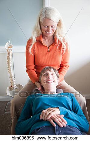 Caucasian chiropractor massaging neck of client View Large Photo Image Stock Photography - Caucasian chiropractor massaging neck of client. Fotosearch