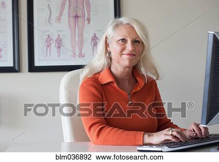Caucasian chiropractor working at computer View Large Photo Image Stock Image - Caucasian chiropractor working at computer. Fotosearch