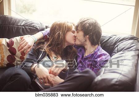 Caucasian couple kissing on sofa View Large Photo Image Stock Image - Caucasian couple kissing on sofa. Fotosearch