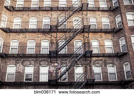 Caucasian couple standing on apartment fire escape View Large Photo Image Stock Image - Caucasian couple standing on apartment fire escape. Fotosearch