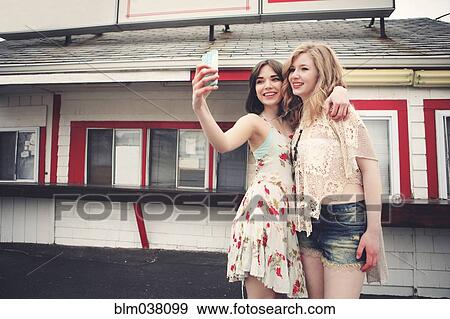 Caucasian friends taking selfie with cell phone View Large Photo Image Stock Photo - Caucasian friends taking selfie with cell phone. Fotosearch