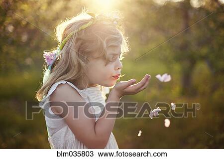 Caucasian girl blowing flower petals outdoors View Large Photo Image Stock Image - Caucasian girl blowing flower petals outdoors. Fotosearch