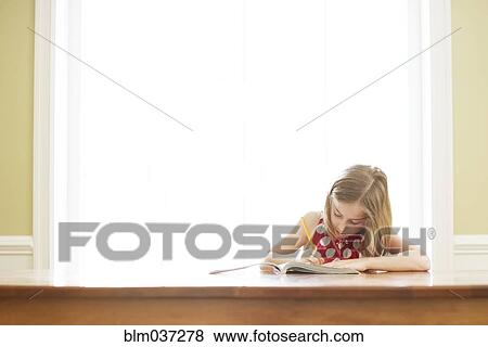 Caucasian girl doing homework at table View Large Photo Image Stock Photo - Caucasian girl doing homework at table. Fotosearch