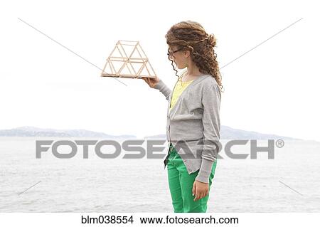 Picture - Caucasian girl examining project. Fotosearch