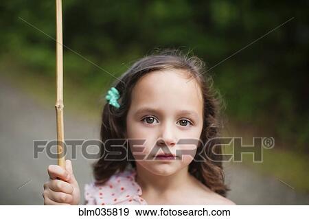 Stock Photo - Caucasian girl holding butterfly net. Fotosearch