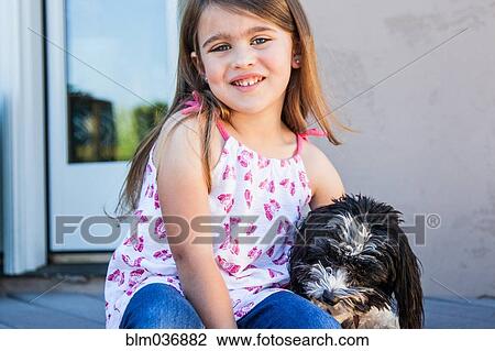 Caucasian girl hugging puppy on patio View Large Photo Image Stock Image - Caucasian girl hugging puppy on patio. Fotosearch