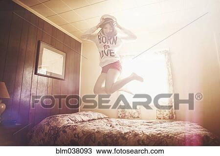 Caucasian girl in captain hat jumping on bed View Large Photo Image Stock Image - Caucasian girl in captain hat jumping on bed. Fotosearch