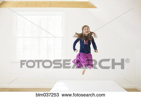 Caucasian girl jumping on bed View Large Photo Image Stock Image - Caucasian girl jumping on bed. Fotosearch