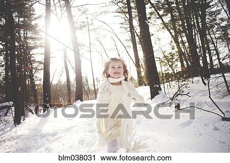 Caucasian girl running in snowy forest View Large Photo Image Stock Image - Caucasian girl running in snowy forest. Fotosearch