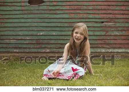 Caucasian girl sitting in backyard View Large Photo Image Stock Image - Caucasian girl sitting in backyard. Fotosearch