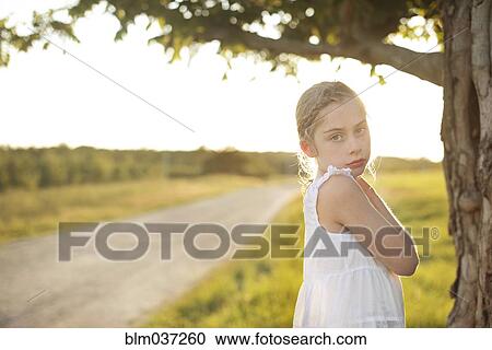 Caucasian girl standing in rural field View Large Photo Image Stock Image - Caucasian girl standing in rural field. Fotosearch