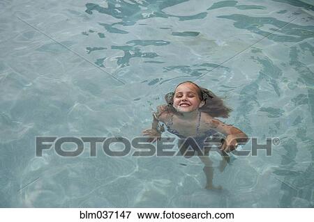 Stock Photo - Caucasian girl swimming in pool. Fotosearch