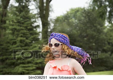 Stock Image - Caucasian girl walking in rural field. Fotosearch