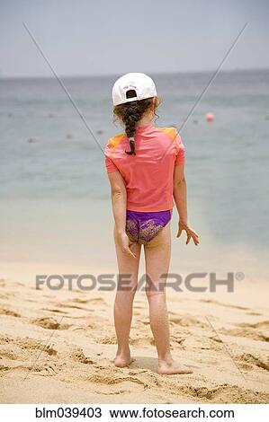 Caucasian girl walking on beach View Large Photo Image Stock Image - Caucasian girl walking on beach. Fotosearch