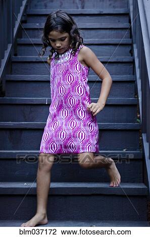 Stock Image - Caucasian girl walking on steps. Fotosearch