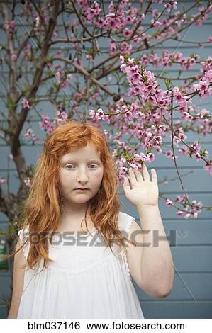Caucasian girl waving under flowering tree View Large Photo Image Stock Photograph - Caucasian girl waving under flowering tree. Fotosearch