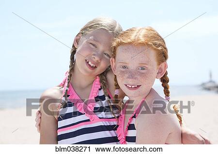 Caucasian girls hugging on beach View Large Photo Image Stock Image - Caucasian girls hugging on beach. Fotosearch