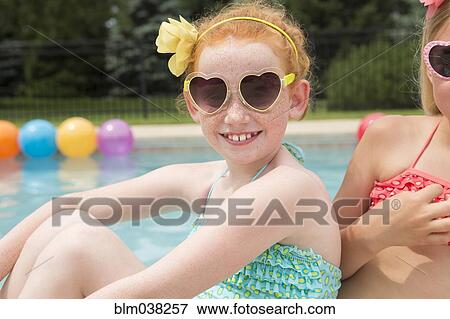 Caucasian girls smiling near swimming pool View Large Photo Image Stock Photo - Caucasian girls smiling near swimming pool. Fotosearch