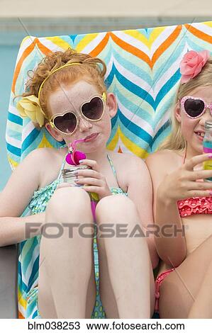 Caucasian girls sunbathing and drinking soda View Large Photo Image Stock Image - Caucasian girls sunbathing and drinking soda. Fotosearch