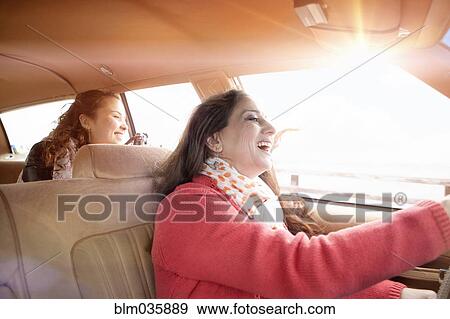Caucasian mother and daughter driving in car View Large Photo Image Stock Photo - Caucasian mother and daughter driving in car. Fotosearch
