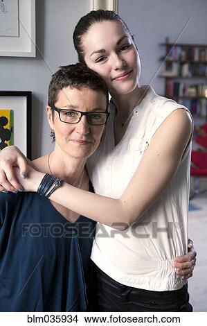 Caucasian mother and daughter hugging View Large Photo Image Picture - Caucasian mother and daughter hugging. Fotosearch