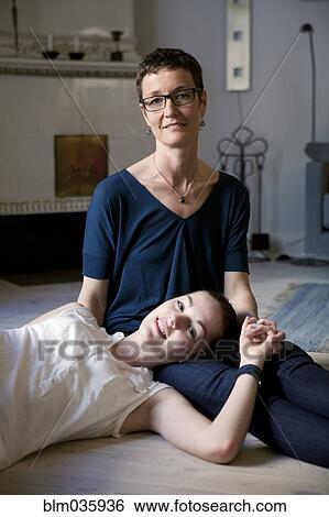 Caucasian mother and daughter hugging on floor View Large Photo Image Stock Photograph - Caucasian mother and daughter hugging on floor. Fotosearch