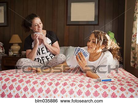 Caucasian mother and daughter playing cards in bedroom View Large Photo Image Stock Photograph - Caucasian mother and daughter playing cards in bedroom. Fotosearch
