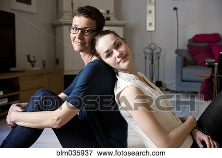 Caucasian mother and daughter sitting back to back View Large Photo Image Stock Photo - Caucasian mother and daughter sitting back to back. Fotosearch