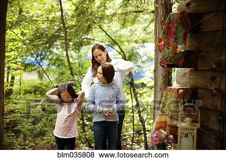 Caucasian mother brushing hair of daughter View Large Photo Image Stock Photo - Caucasian mother brushing hair of daughter. Fotosearch