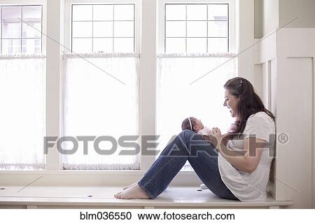 Caucasian mother cradling baby girl View Large Photo Image Stock Image - Caucasian mother cradling baby girl. Fotosearch
