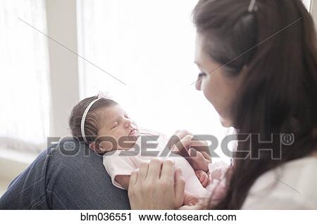 Caucasian mother cradling baby girl View Large Photo Image Stock Image - Caucasian mother cradling baby girl. Fotosearch