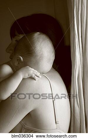 Caucasian mother holding crying baby View Large Photo Image Picture - Caucasian mother holding crying baby. Fotosearch