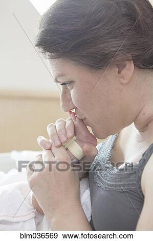 Caucasian mother kissing foot of newborn daughter View Large Photo Image Stock Photo - Caucasian mother kissing foot of newborn daughter. Fotosearch