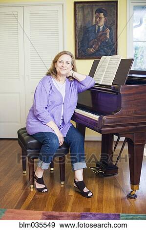 Caucasian musician sitting at piano View Large Photo Image Stock Photo - Caucasian musician sitting at piano. Fotosearch