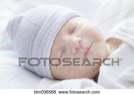 Caucasian newborn girl wearing cap View Large Photo Image Stock Photo - Caucasian newborn girl wearing cap. Fotosearch
