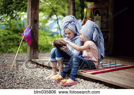 Caucasian sisters with hair towels examining bird nest View Large Photo Image Stock Photograph - Caucasian sisters with hair towels examining bird nest. Fotosearch