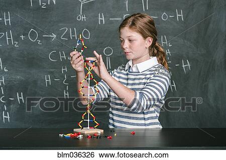 Stock Photograph - Caucasian student examining molecular model in science class. Fotosearch