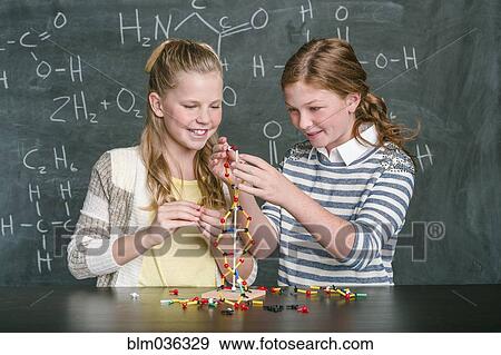 Caucasian students examining molecular model in science class View Large Photo Image Stock Photo - Caucasian students examining molecular model in science class. Fotosearch
