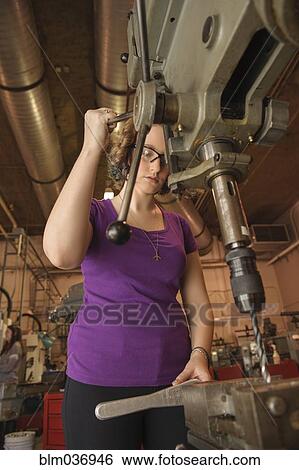 Caucasian technician using drill machinery in warehouse View Large Photo Image Stock Photograph - Caucasian technician using drill machinery in warehouse. Fotosearch