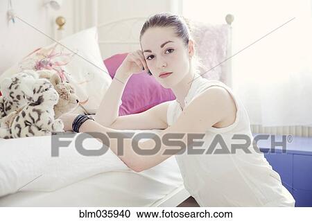 Caucasian teenage girl leaning on bed View Large Photo Image Stock Image - Caucasian teenage girl leaning on bed. Fotosearch