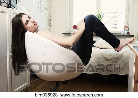 Caucasian teenage girl sitting in armchair View Large Photo Image Stock Photo - Caucasian teenage girl sitting in armchair. Fotosearch