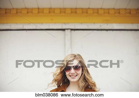 Stock Photograph - Caucasian teenage girl smiling in sunglasses. Fotosearch