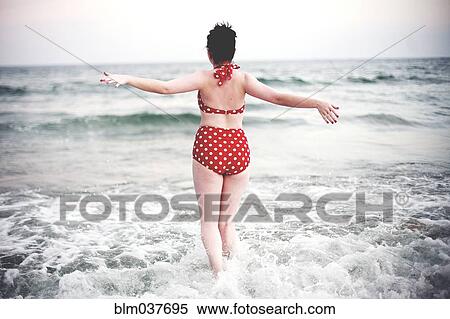 Caucasian teenage girl splashing in ocean waves View Large Photo Image Stock Photography - Caucasian teenage girl splashing in ocean waves. Fotosearch