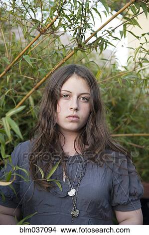 Caucasian teenage girl standing in branches View Large Photo Image Picture - Caucasian teenage girl standing in branches. Fotosearch