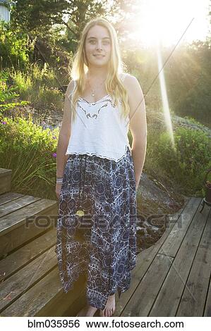 Caucasian teenage girl standing on wooden walkway View Large Photo Image Stock Photograph - Caucasian teenage girl standing on wooden walkway. Fotosearch