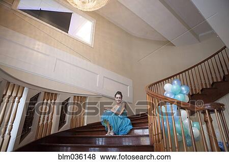 Stock Photo - Caucasian teenage girl wearing formal dress on steps. Fotosearch
