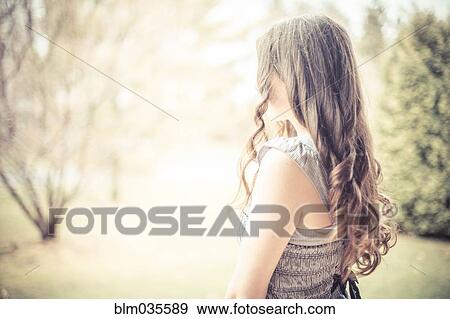Caucasian teenage girl with curly hair outdoors View Large Photo Image Stock Photo - Caucasian teenage girl with curly hair outdoors. Fotosearch