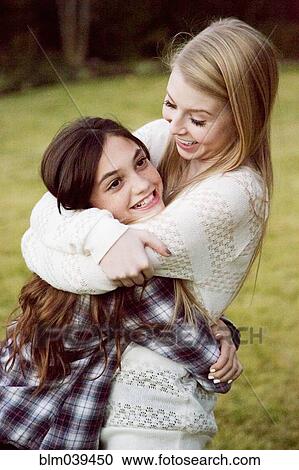 Caucasian teenage girls hugging in backyard View Large Photo Image Stock Image - Caucasian teenage girls hugging in backyard. Fotosearch